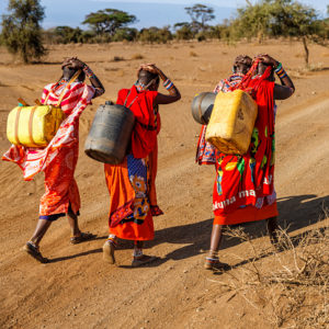 African women from Maasai tribe carrying water, Kenya, East Africa