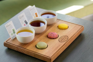 A tea and macaron pairing flight with three different teas and macarons from Smith Teamaker.