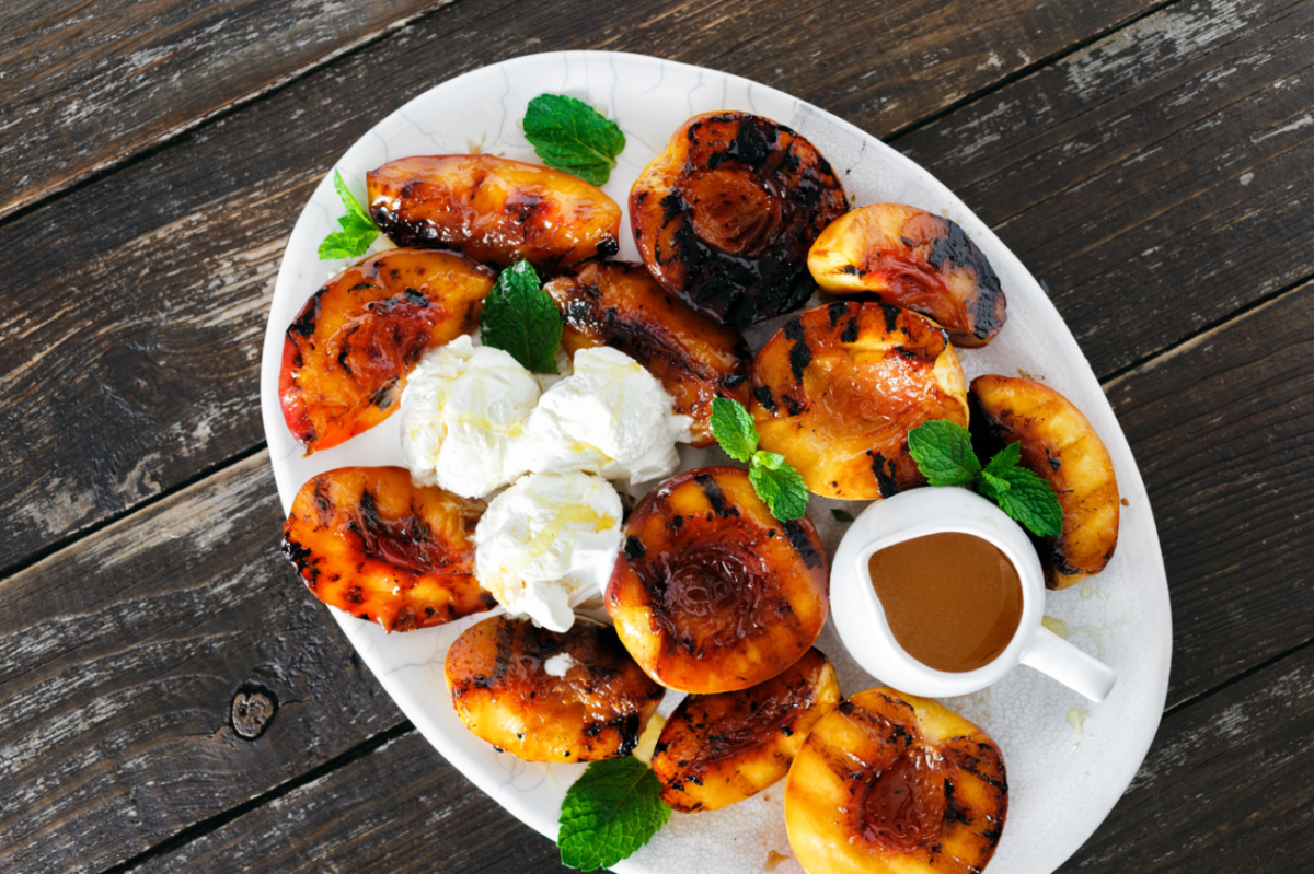Grill summer ripe peaches and top them with an aromatic Earl Grey simple syrup for a mouthwatering dessert.